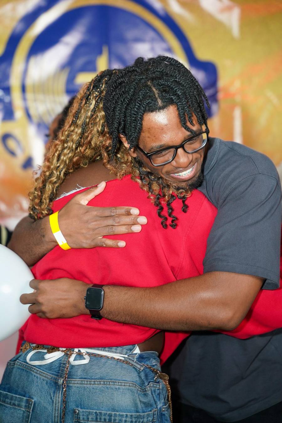 Two people embracing at a Christ FM event