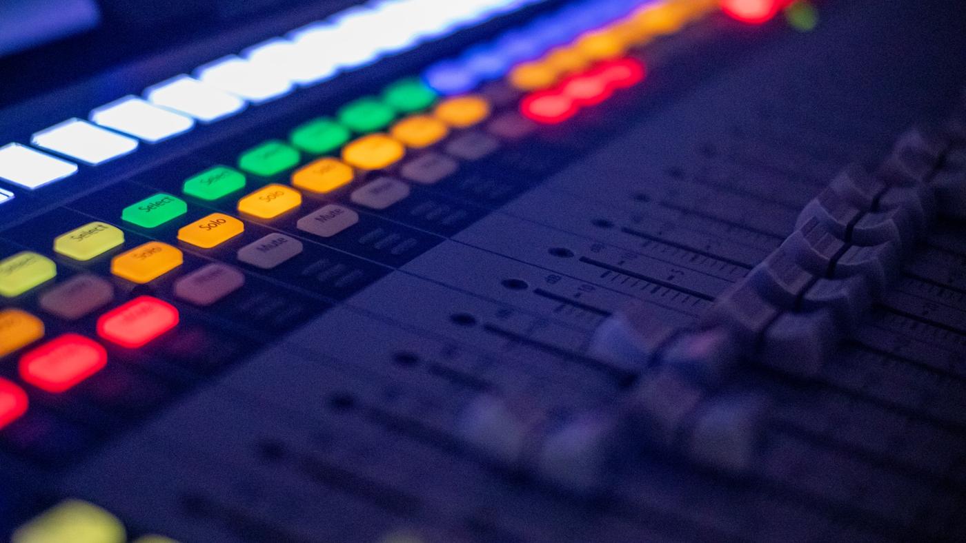 Close detail of illuminated audio-console controls